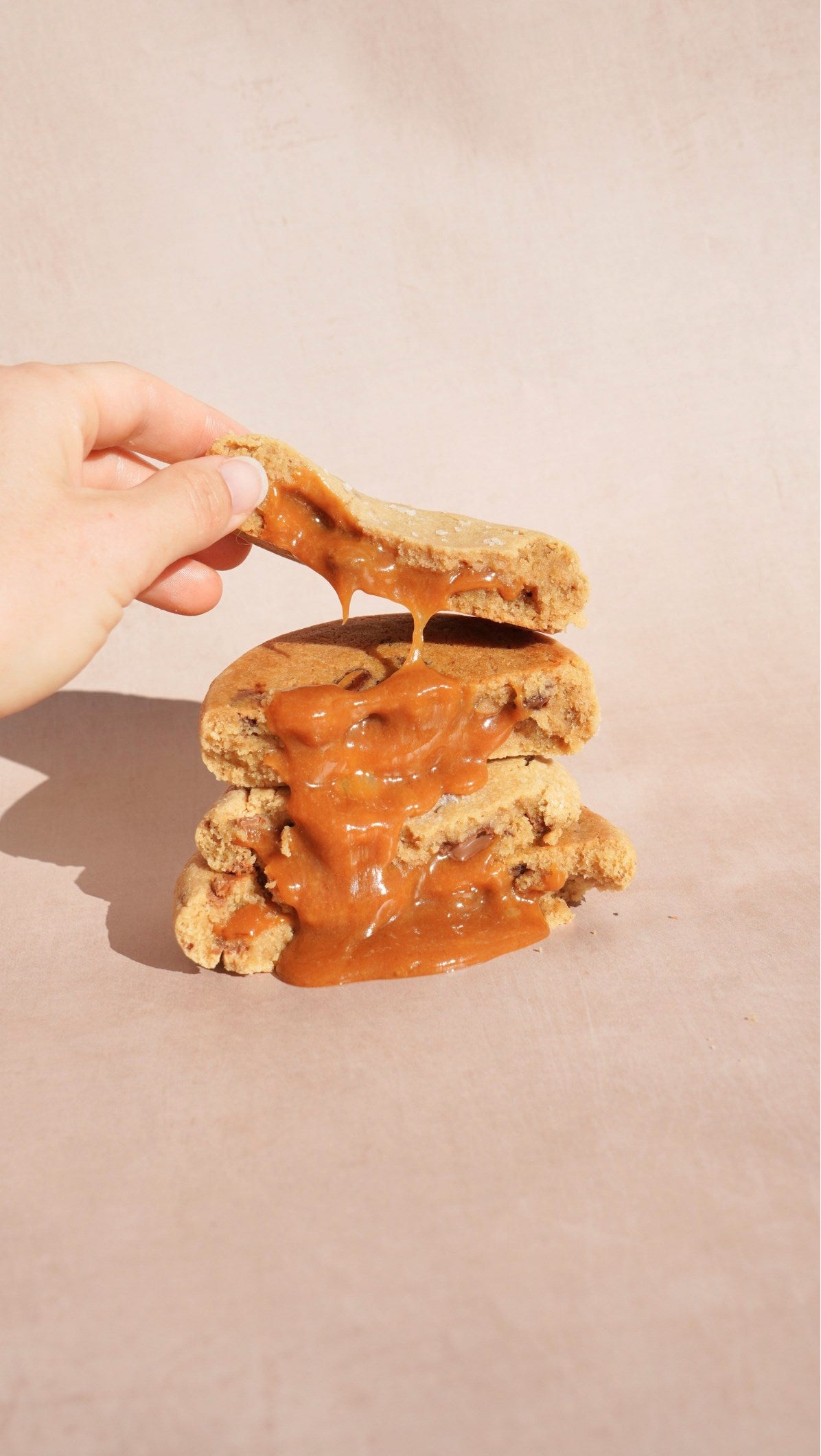 A gooey stuffed cookie being pulled apart